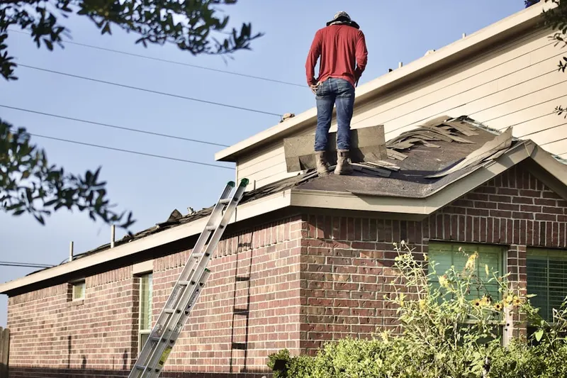 Professional roofer working on a residential roof in Lorain